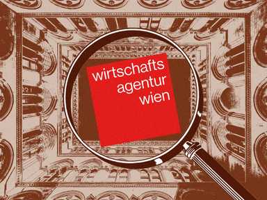 Das Wirtschaftsagenturlogo wird unter die Lupe genommen, im Hintergrund das Wiener Rathaus.